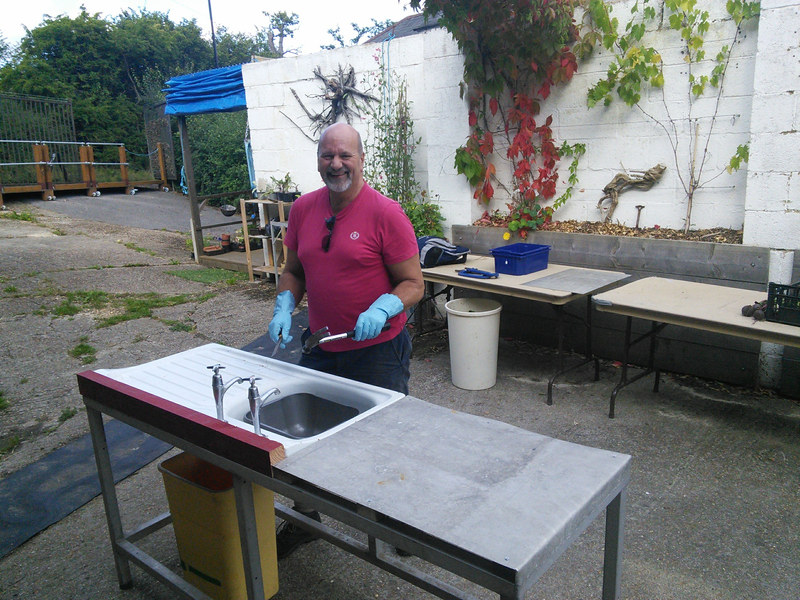 Volunteer Mark puts finishing touches to washing up station